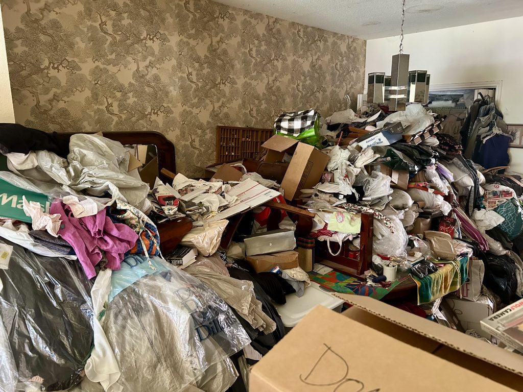 Cluttered room full of belongings parents leave behind before decluttering, Houston